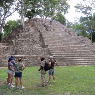 Travelers exploring a Maya archaeological site in Belize