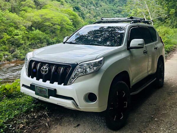 Brand new white Toyota Land Cruiser 4x4 parked in Belize, offering rugged comfort for private tours—part of premium Belize transportation services.