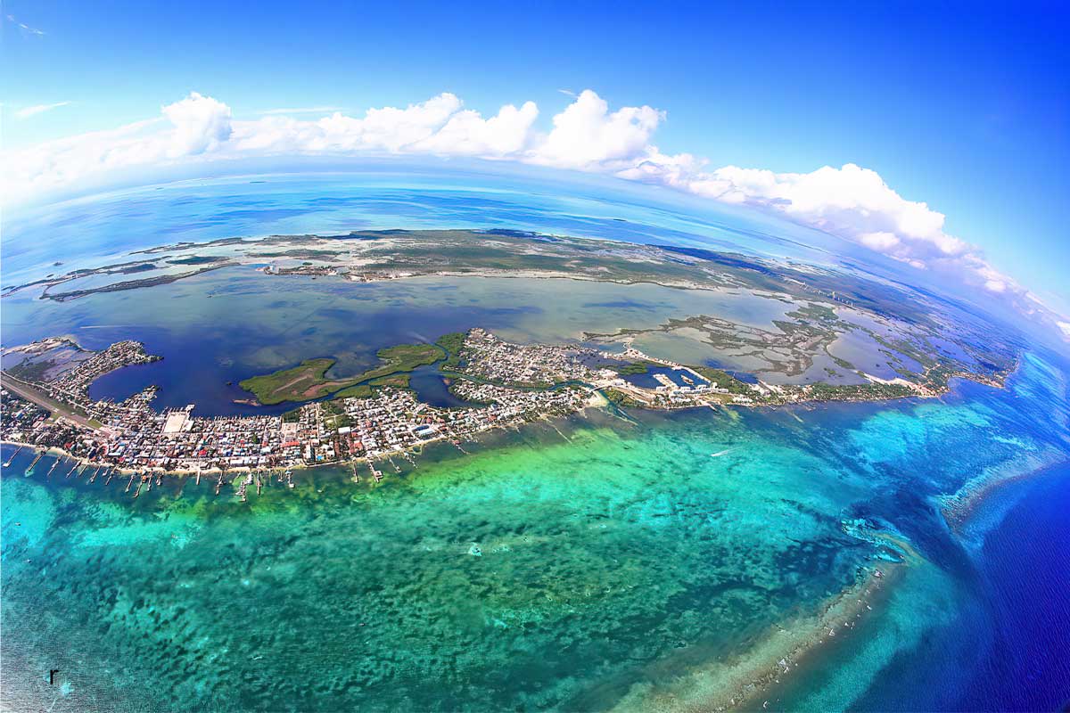 Aerial view of Ambergris Caye, Belize showcasing turquoise waters, beachfront villas, and private docks — representing the best all-inclusive resorts in Ambergris Caye.