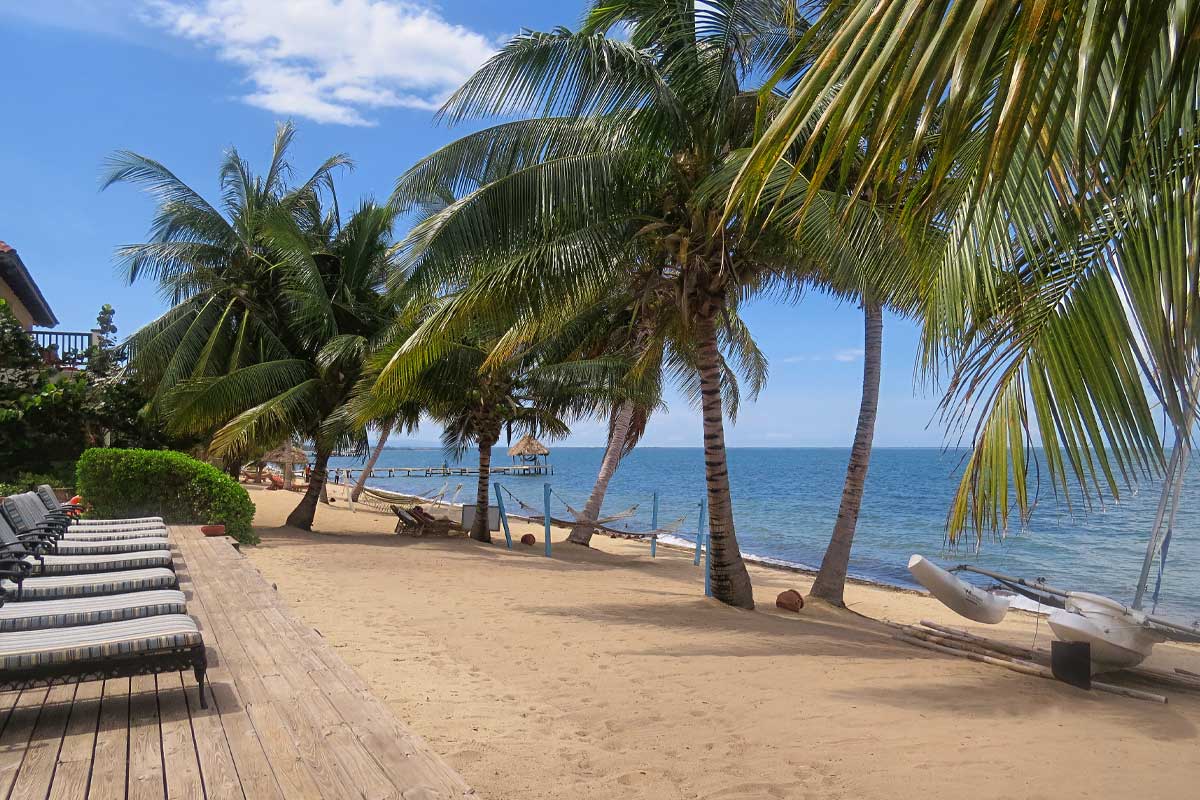HopkinsBelize Is Belize safe for tourists? Relax on the sandy beaches of Hopkins, where turquoise waters, coconut trees, and a blue sky showcase Belize’s safe, stunning beauty.