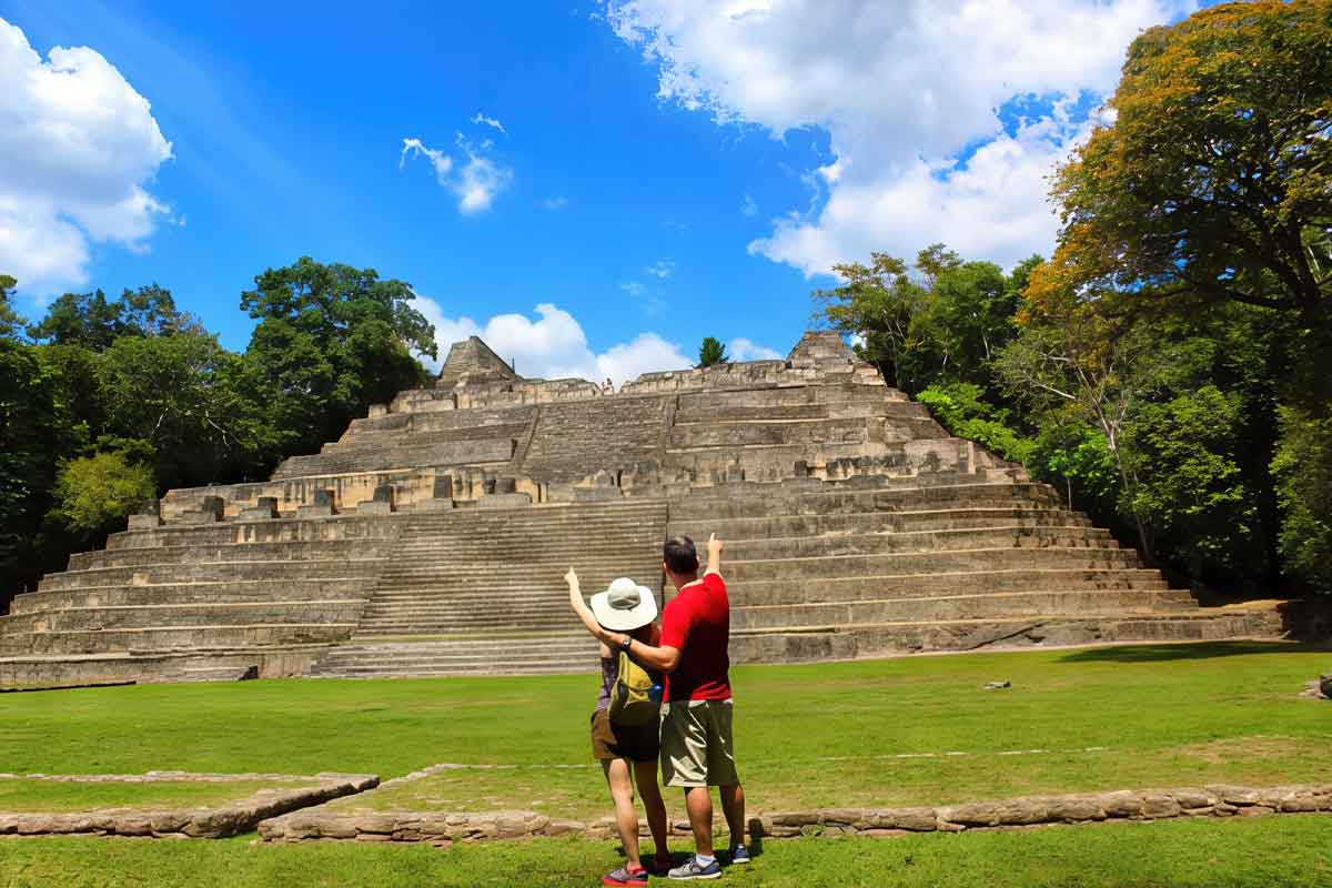 Caracol-Mayan-Site Couple standing in front of El Castillo at Xunantunich Maya site in Cayo District Belize.