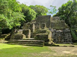 Lamanai-Archaeological-Site - Authentic Travel Belize Lamanai ruins surrounded by tropical forest near the New River in Orange Walk Belize, showcasing ancient Maya architecture and northern Belize heritage.